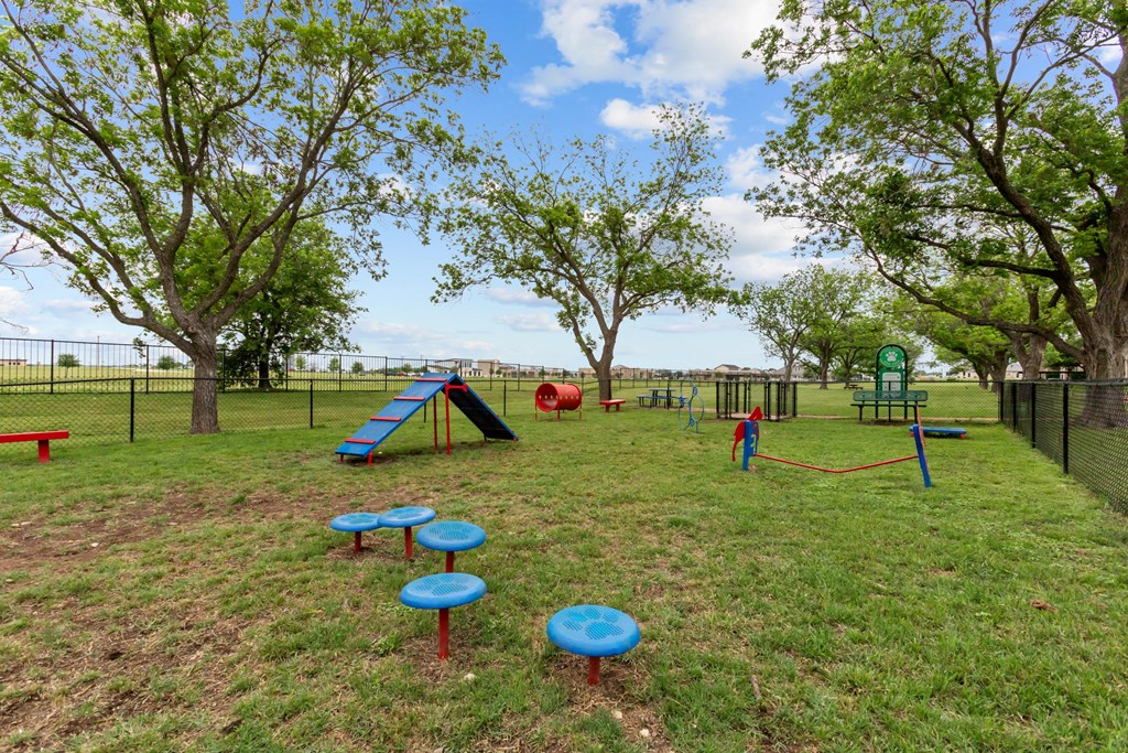 A playground with a slide, swings, and a ball pit.