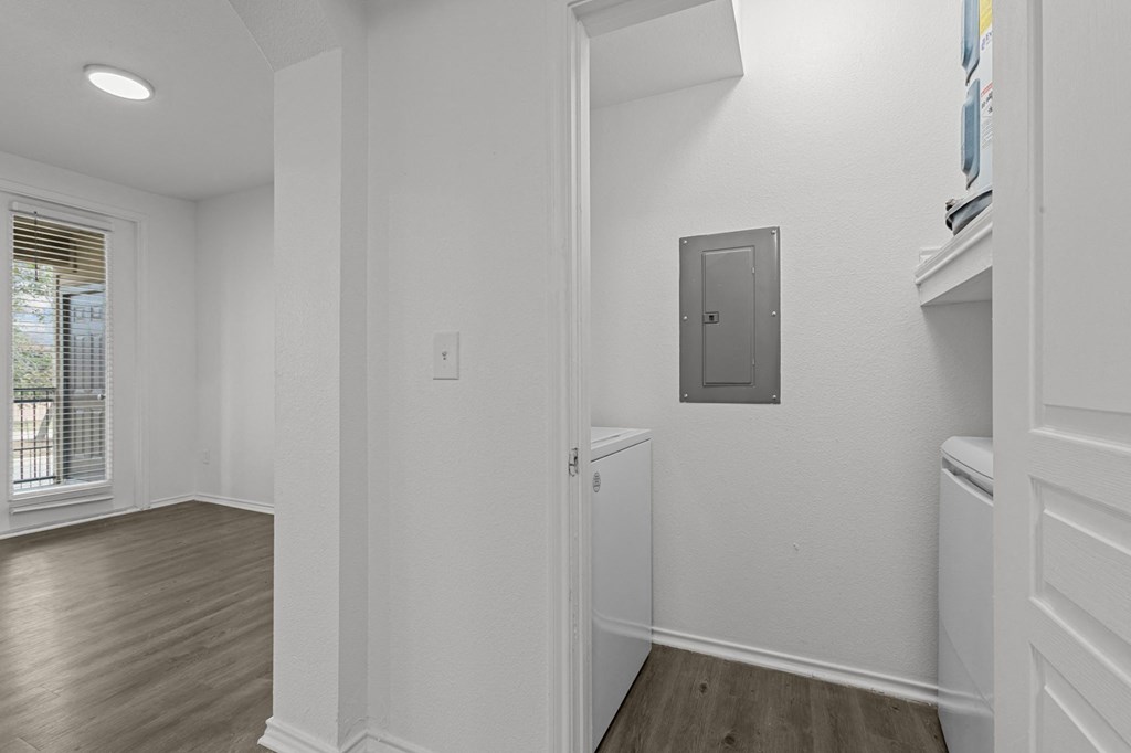 A white room with a door and a window.