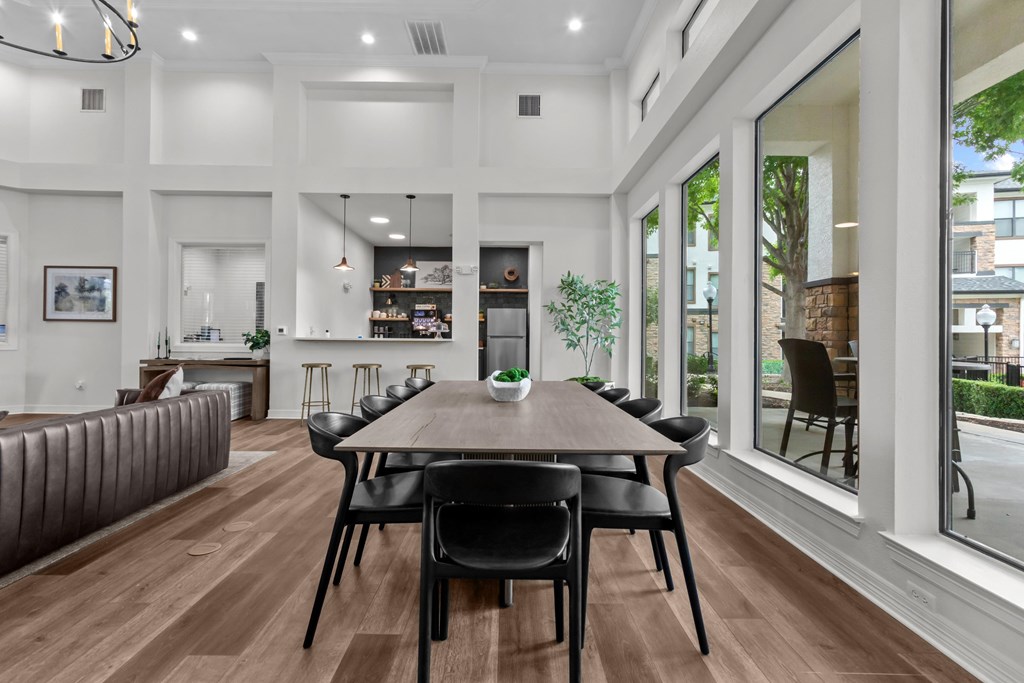 A modern dining room with a wooden table and chairs.