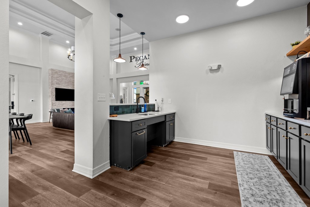 A kitchen area with a counter and cabinets.