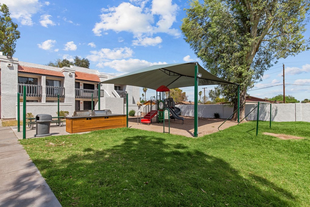 a backyard with a swing set and a playground