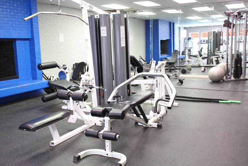 a gym with weights and other equipment in it