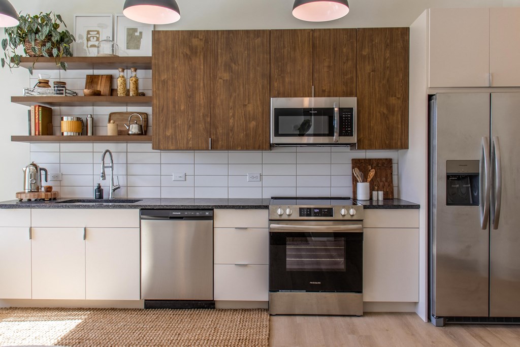 A modern kitchen with a stainless steel dishwasher and oven.