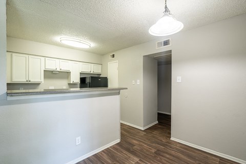 A kitchen area with a counter and cabinets.