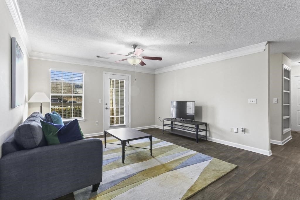 a living room with a couch and a ceiling fan