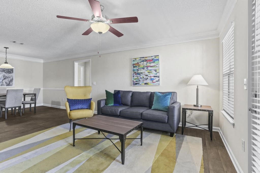 a living room with a couch and a ceiling fan