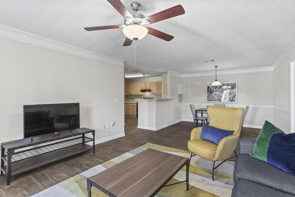 a living room with a couch and a ceiling fan
