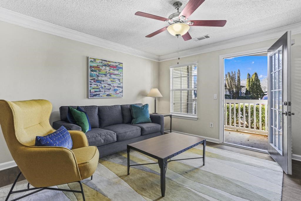 a living room with a couch and a ceiling fan