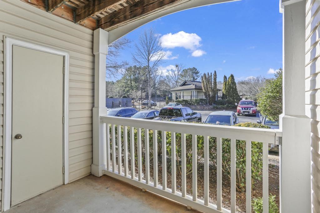 a balcony with a view of a parking lot