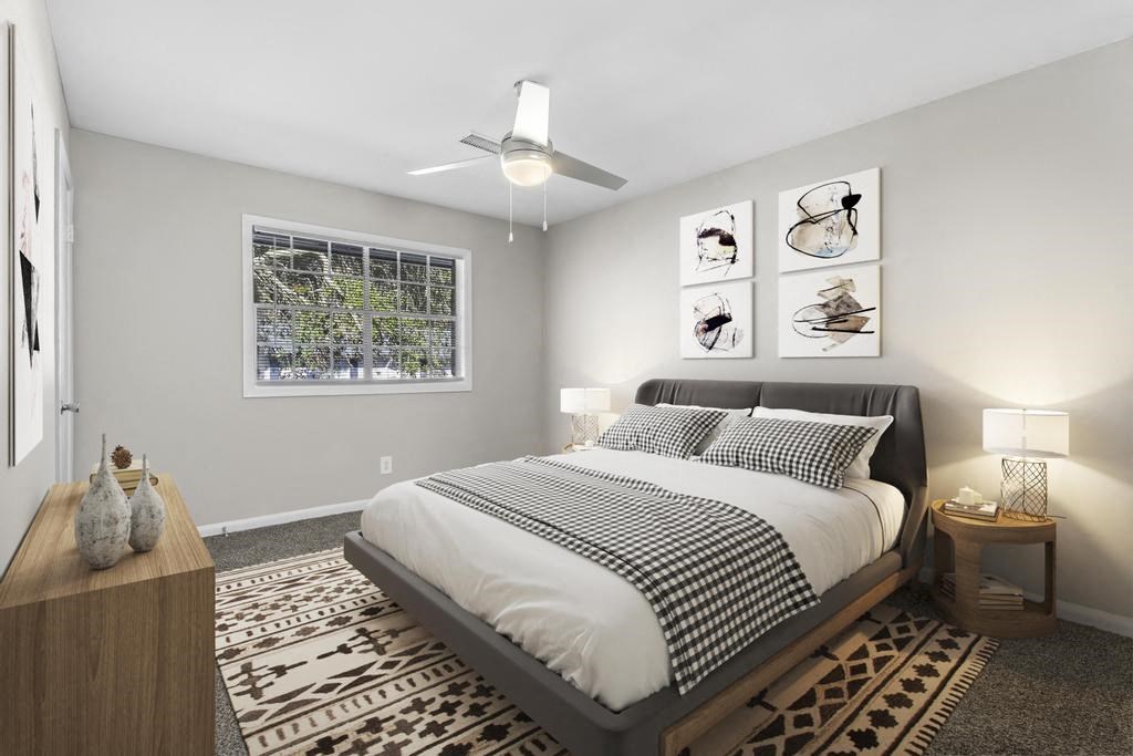 a bedroom with a bed and a ceiling fan