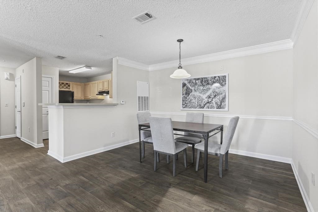 a dining room and kitchen with a table and chairs