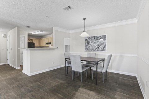 a dining room and kitchen with a table and chairs