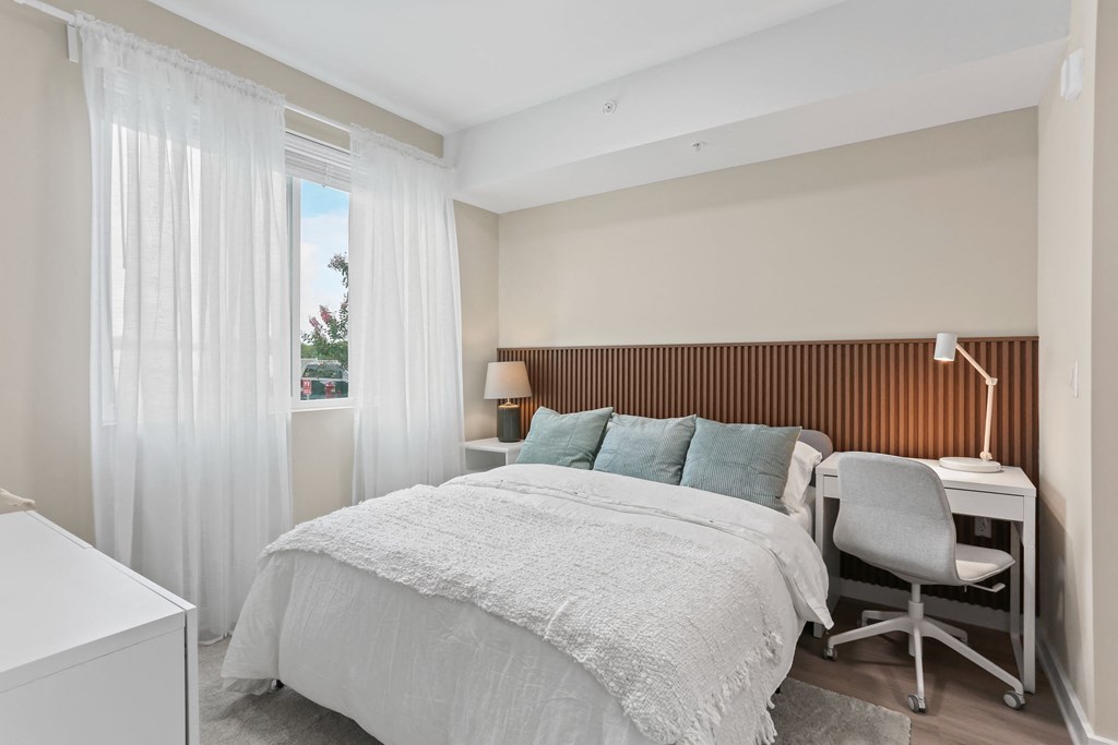 a bedroom with a bed and a desk