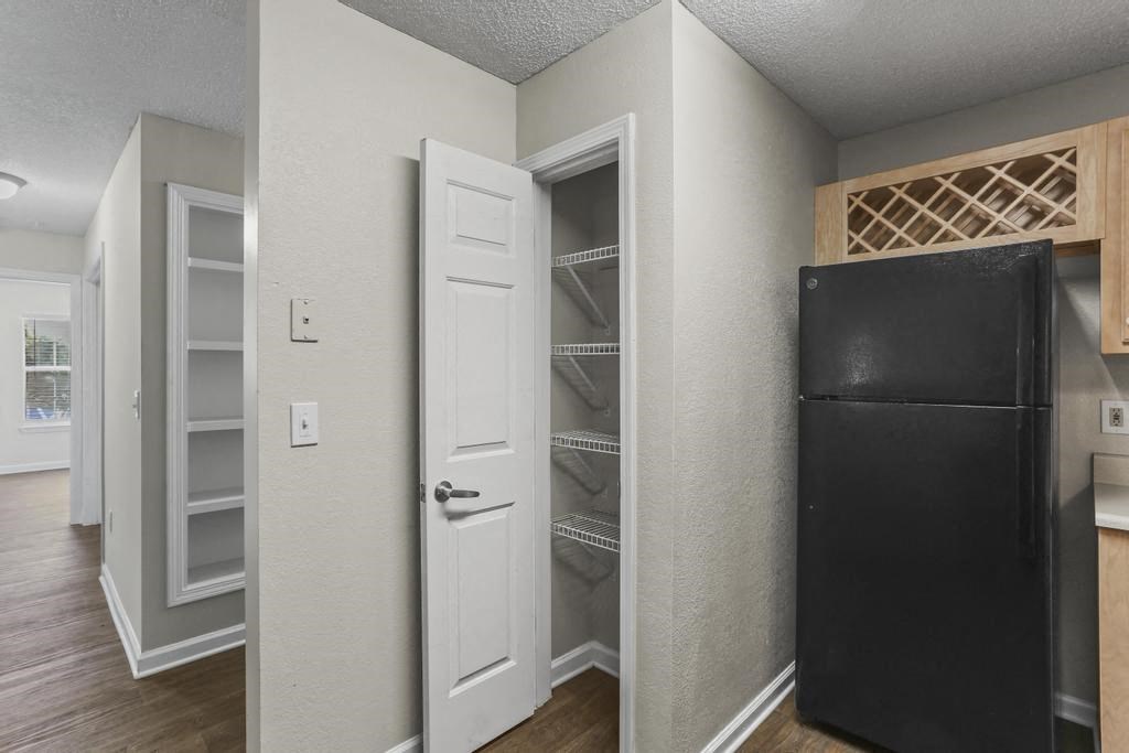 a room with a refrigerator and a closet