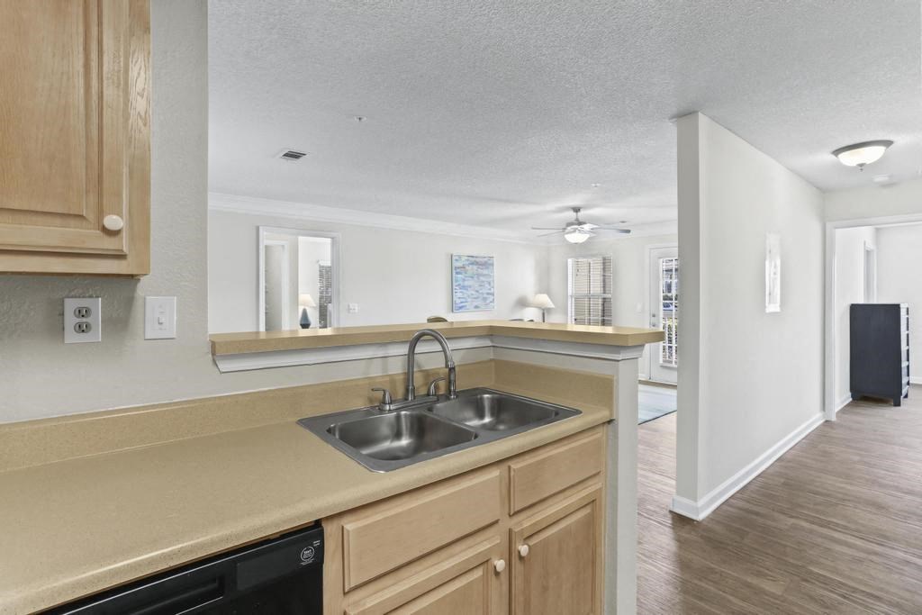 a kitchen with wooden cabinets and a sink