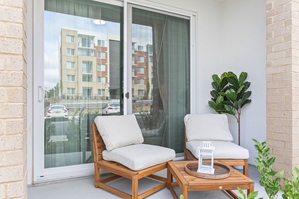 a balcony with two chairs and a table