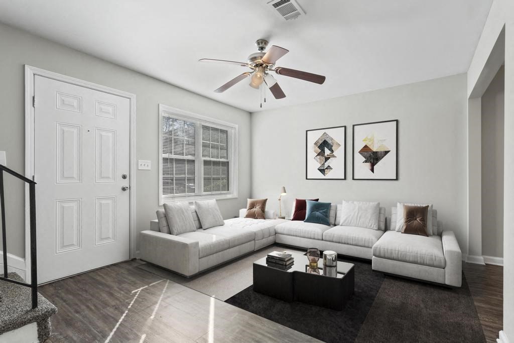 a living room with a couch and a ceiling fan