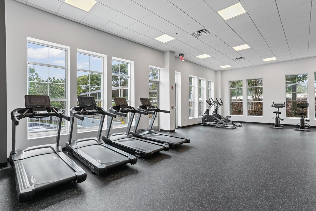 A gym with treadmills and exercise bikes.
