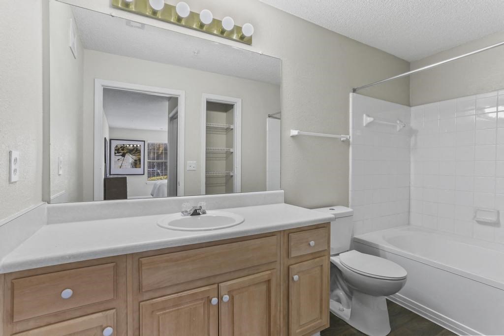 a bathroom with a sink toilet and a mirror