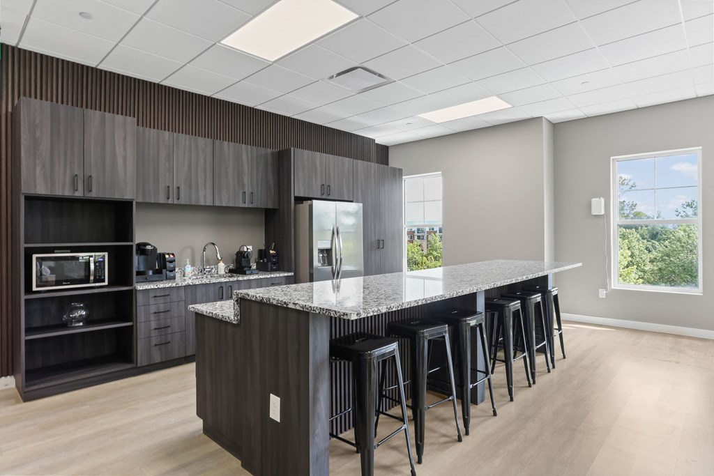 a kitchen with a large island with a granite countertop