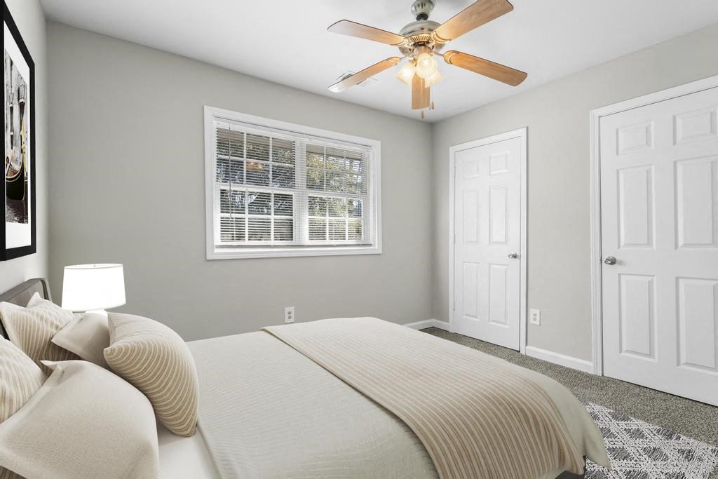 a bedroom with a bed and a ceiling fan