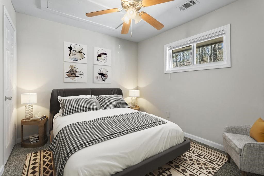 a bedroom with a bed and a ceiling fan