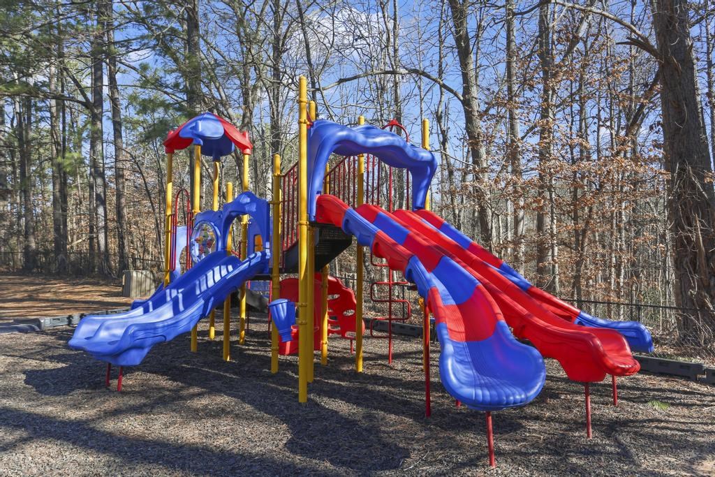 a colorful playground with slides in a park