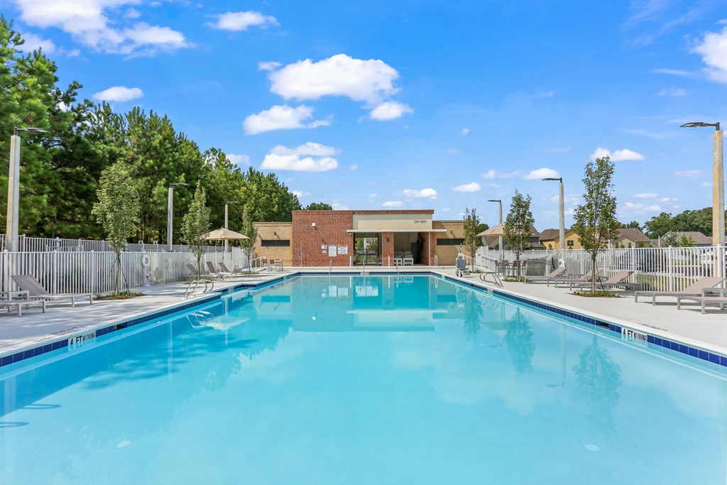 A large swimming pool in a sunny outdoor setting.