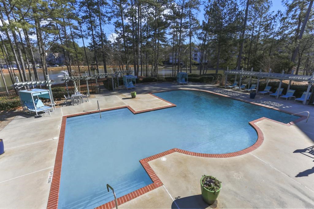 a swimming pool with trees in the background