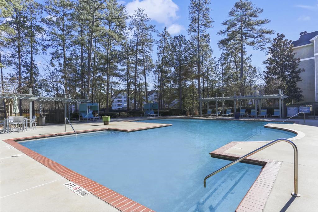 a swimming pool with trees in the background
