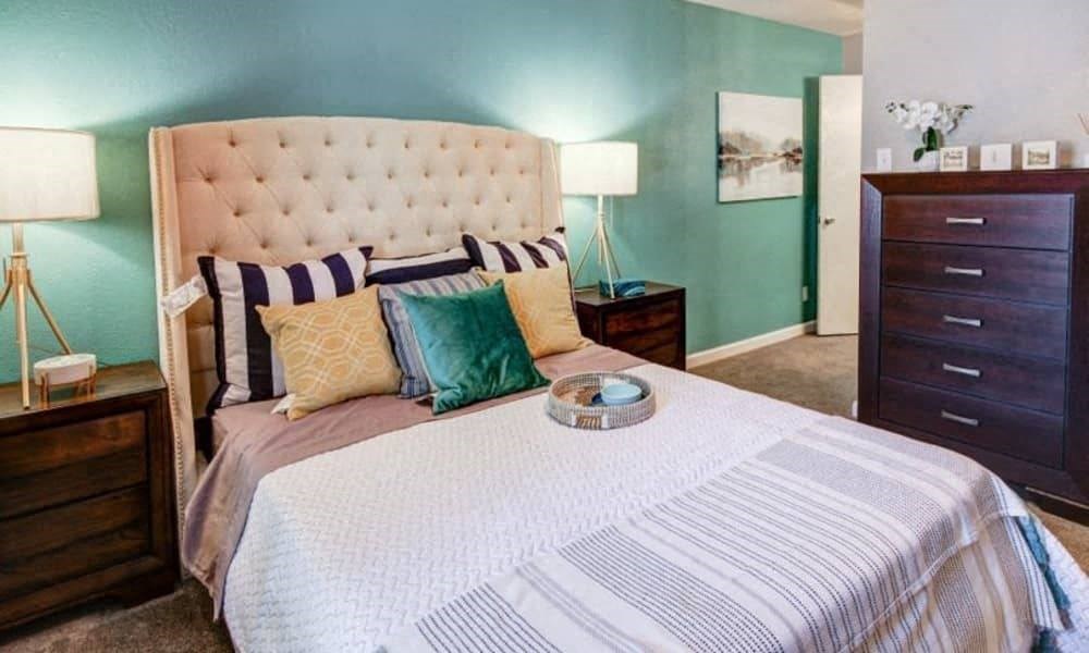 a bedroom with a bed and a dresser