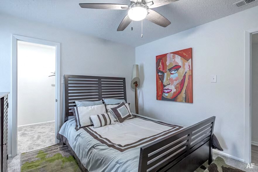 the preserve at ballantyne commons bedroom with bed and ceiling fan