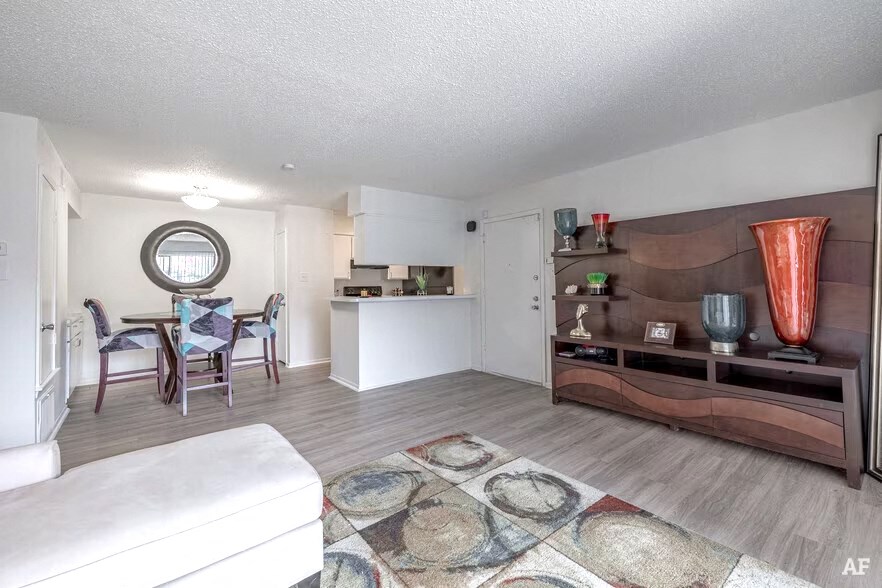 a living room with a couch and a table in a kitchen
