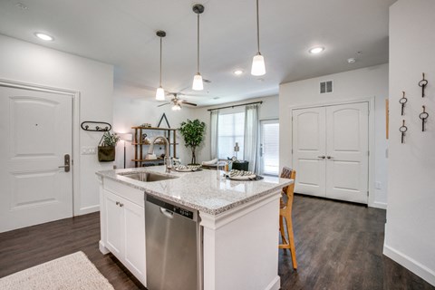 an open kitchen and dining room with white walls and white counter tops
