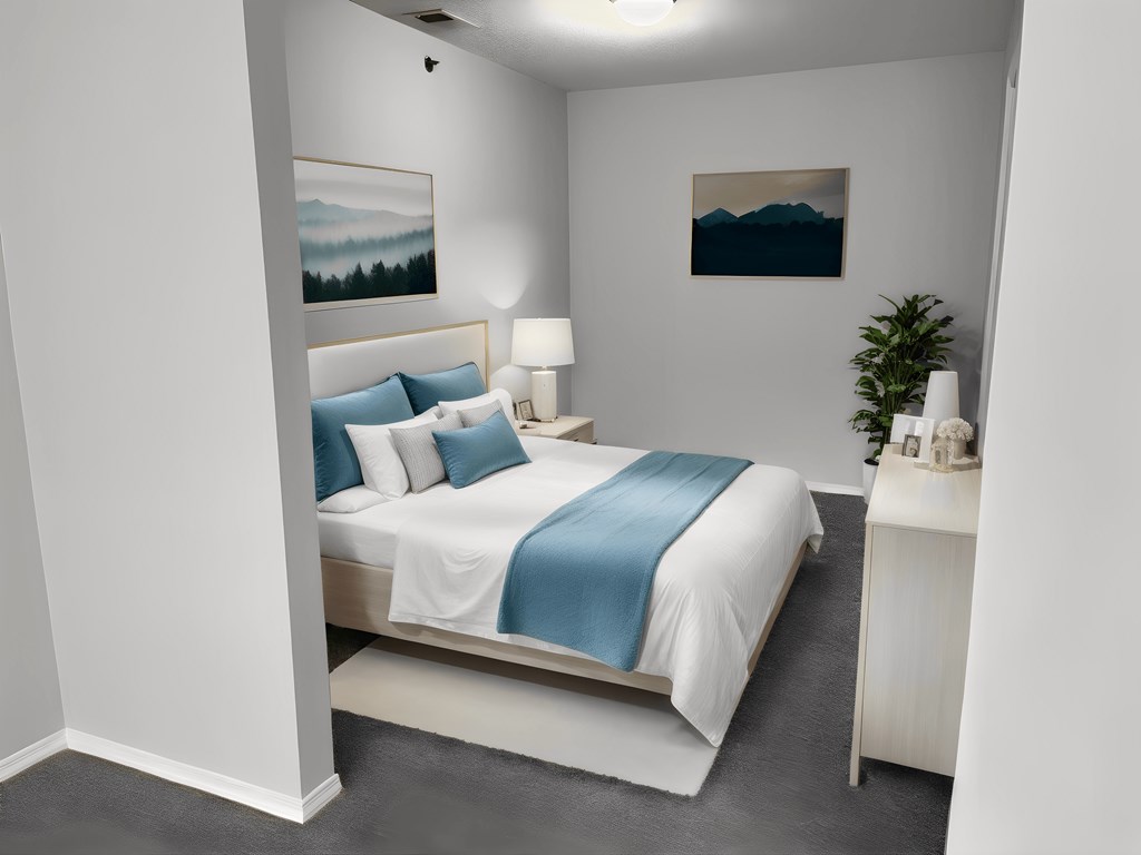 a bedroom with a white bed and blue pillows