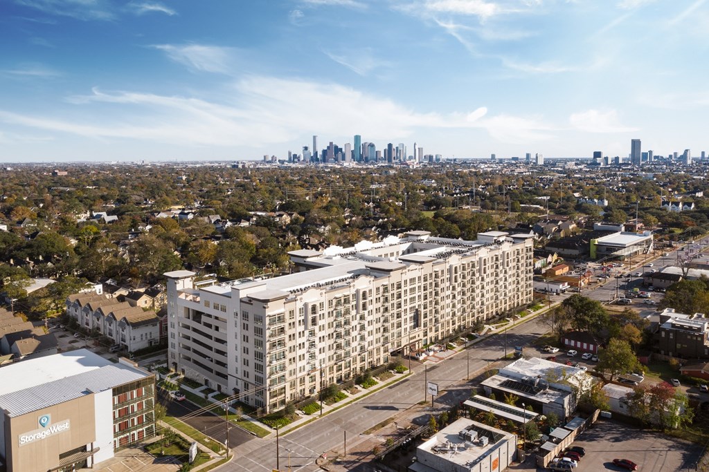 an aerial view of an apartment building with the skyline in the background