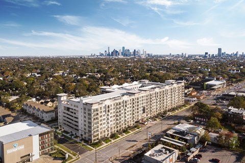 an aerial view of an apartment building with the skyline in the background