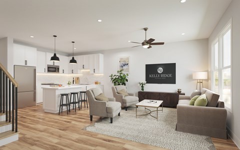 A modern living room with a kitchen area in the background.