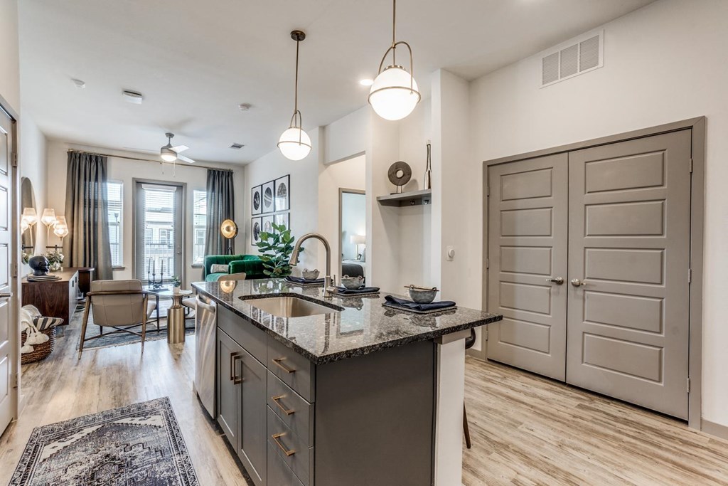 a kitchen with an island and a living room