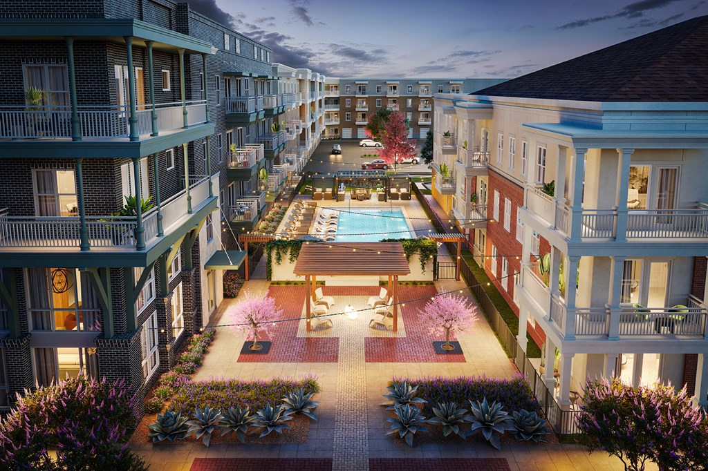 A beautifully lit courtyard surrounded by apartment buildings.