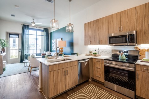 A kitchen with wooden cabinets and a stainless steel oven.