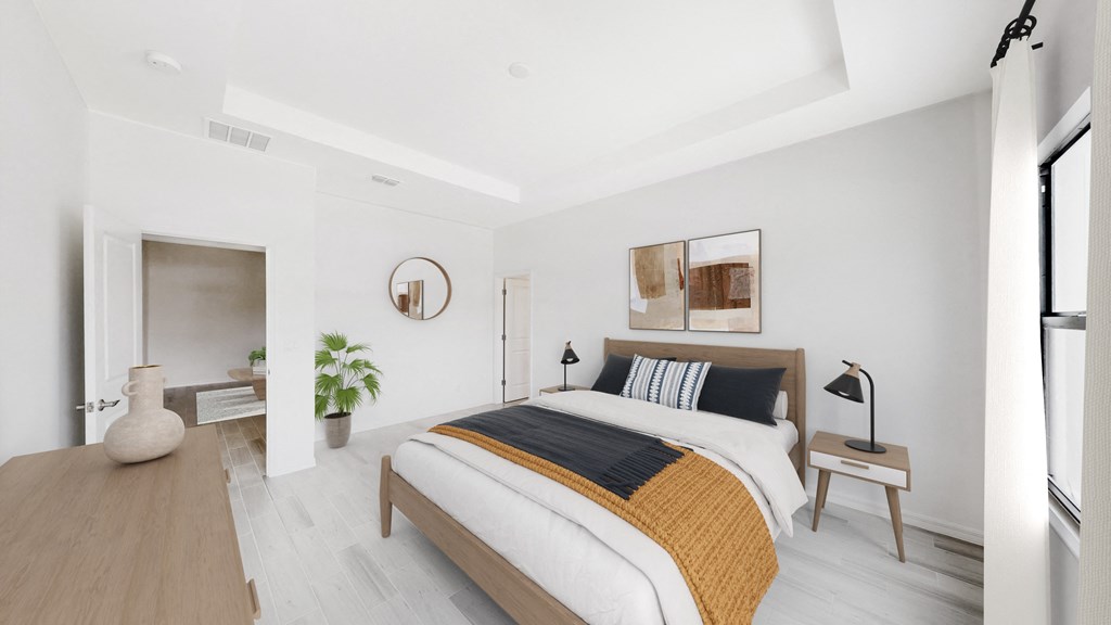 a white bedroom with a bed and a potted plant