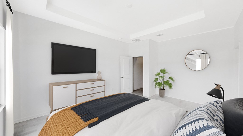 a bedroom with a bed and a tv on the wall