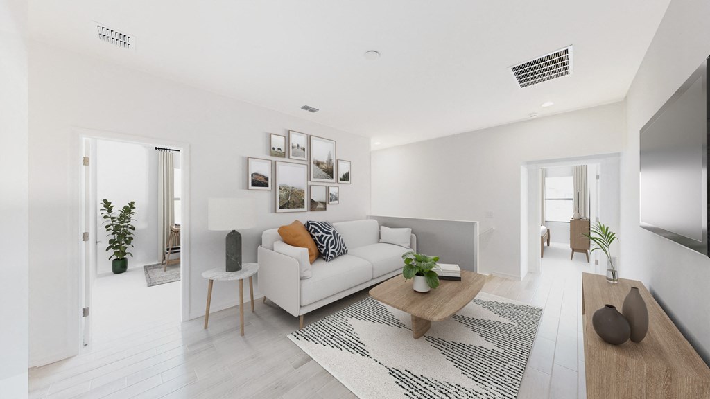 a living room with a white couch and a wooden table