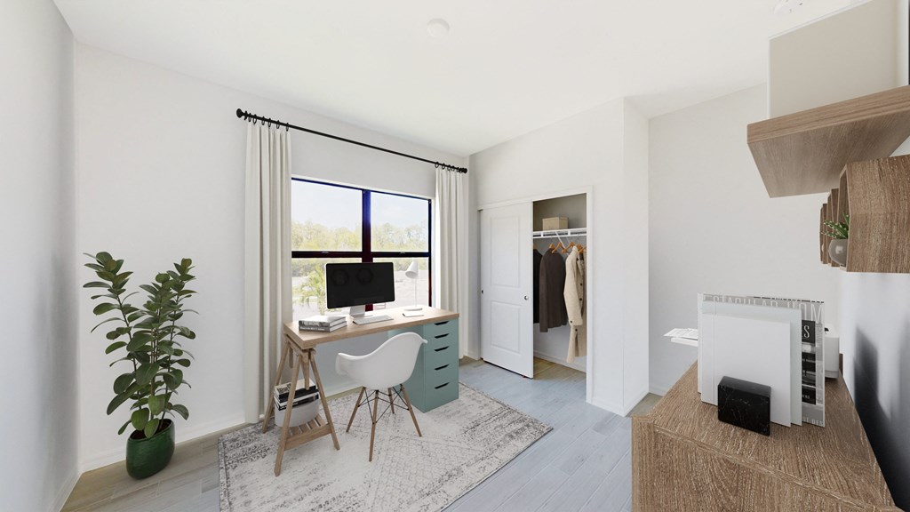 a home office with a desk and a computer in a room with a closet