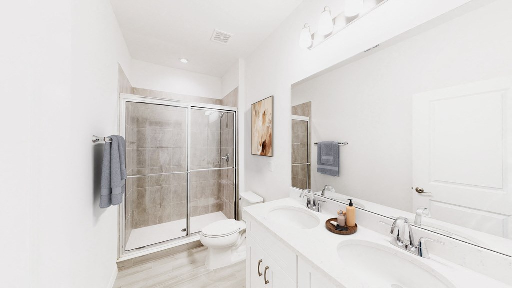a white bathroom with a shower and a sink