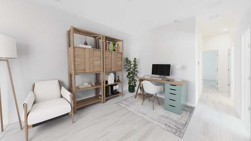a living room with a desk and a chair and a tv