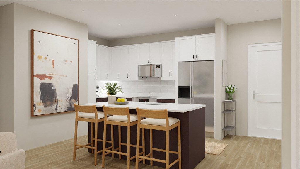 a kitchen with white cabinets and a bar with three stools