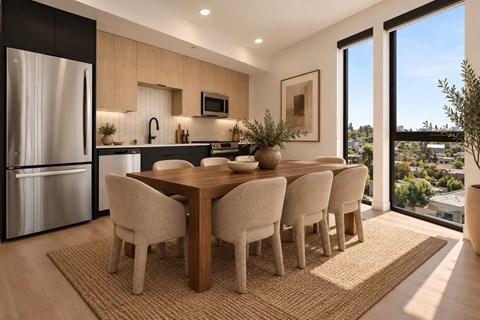 A modern kitchen with a dining table and chairs.