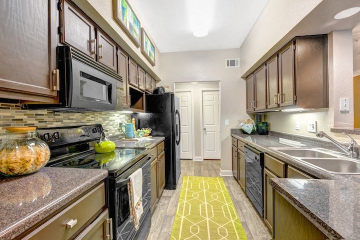 a kitchen with stainless steel appliances and wooden cabinets